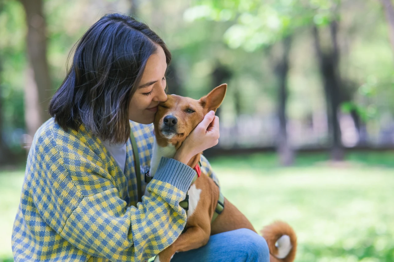 Woman with dog Shutterstock_2333434689