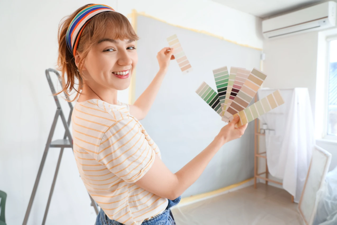 Woman with paint samples Shutterstock_2414247051