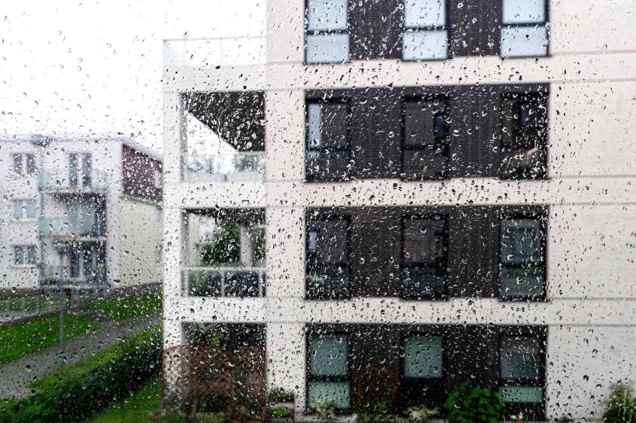Rain on apartment building Shutterstock_2498968459