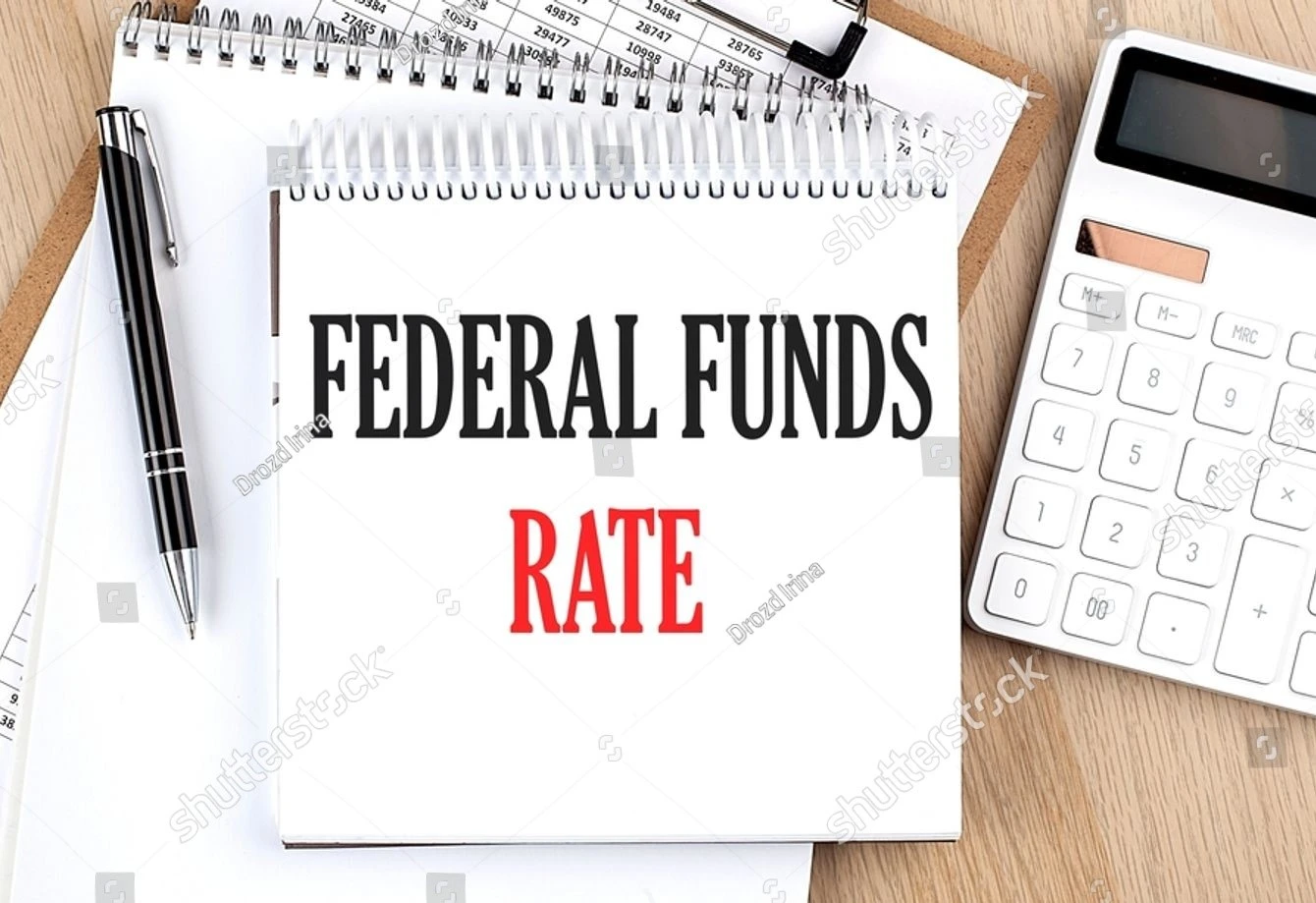 stock-photo-federal-funds-rate-is-written-in-white-notepad-near-calculator-clipboard-and-pen-business-concept-2334920245 (1)